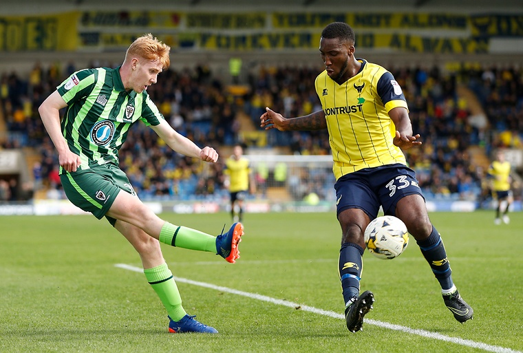 AFC Wimbledon’s Alfie Egan and Oxford United’s Chey Dunkley in action.